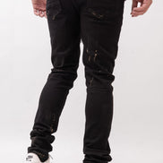 Person wearing black distressed jeans and white sneakers on a white background