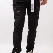 Person wearing black distressed jeans with a visible brand logo on a white background