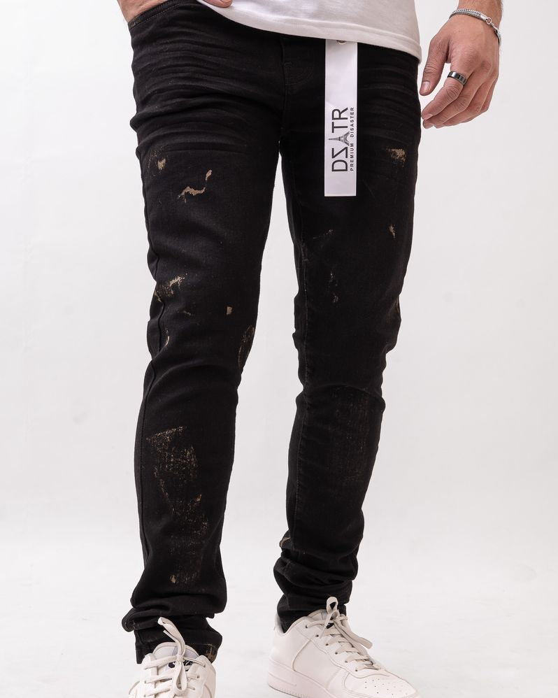 Person wearing black distressed jeans with a visible brand logo on a white background