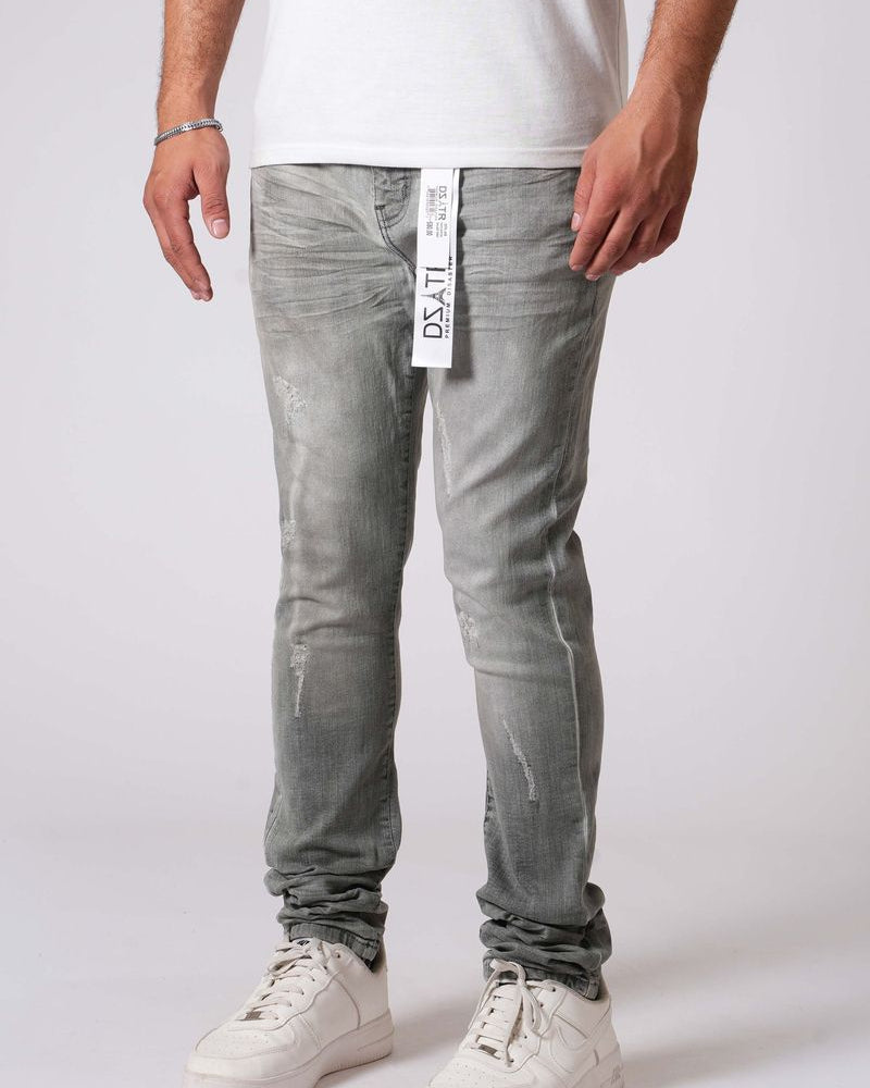 Person wearing light gray jeans with a visible brand label on a white background