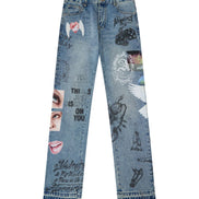 Light blue denim jeans with various graphic prints, stickers, and text overlays, shown flat against a white background.