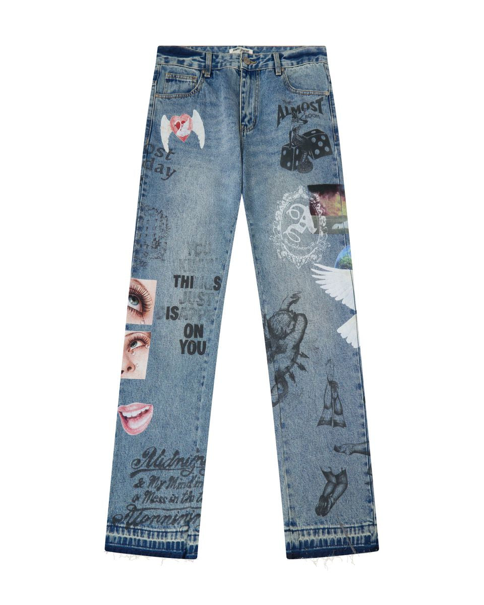 Light blue denim jeans with various graphic prints, stickers, and text overlays, shown flat against a white background.