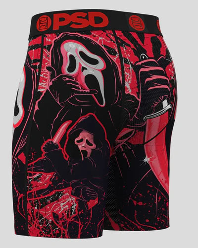 Black shorts with red and white graphic design featuring a mask and other elements on a gray background.