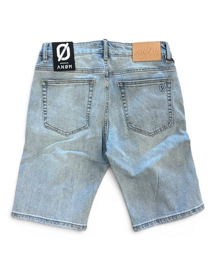 Back view of light blue denim shorts with brand labels on a white background