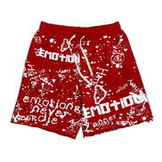 all red sweat shorts with white graffiti designs all over including the brand name mixed emotions. 