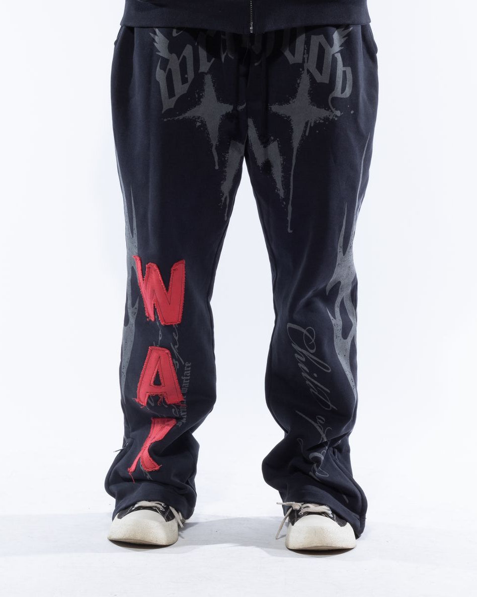 Dark blue pants with red text and white sneakers on a white background