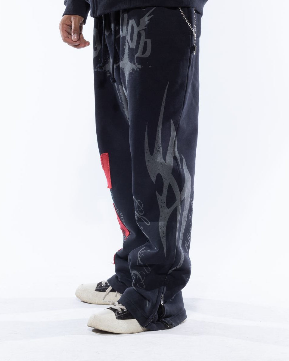 Black pants with gray flame designs and red accents on a white background