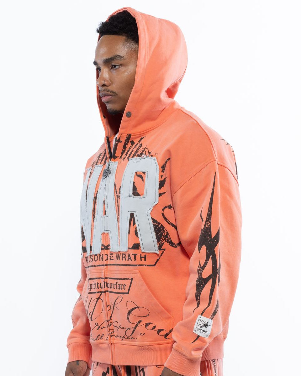 Person wearing a bright orange hoodie with text and graphics on a white background