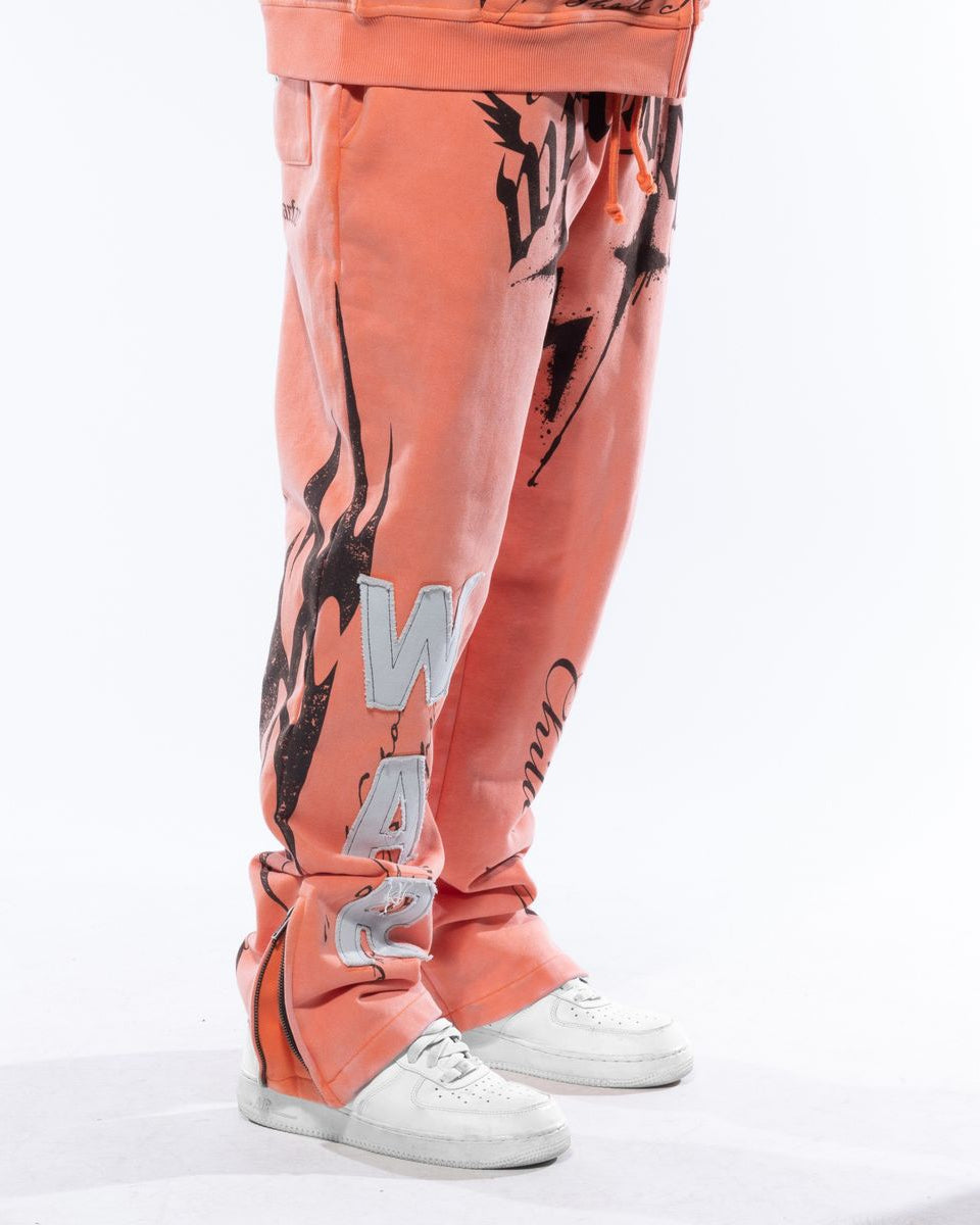 Peach-colored pants with black and white designs on a white background