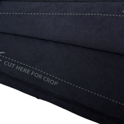 Close-up of a black fabric with stitching details on a white background