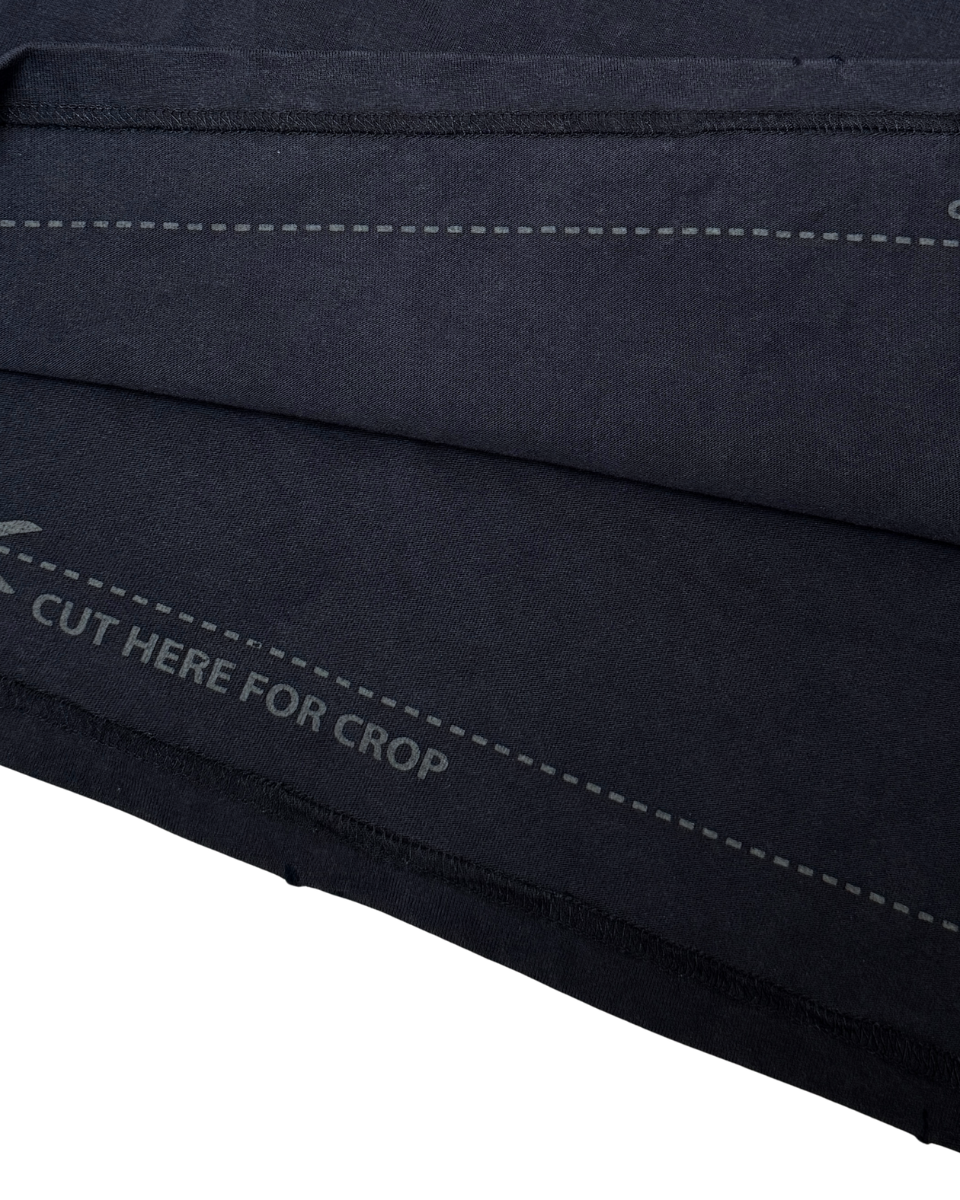 Close-up of a black fabric with stitching details on a white background