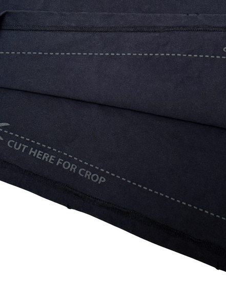 Close-up of a black fabric with stitching details on a white background