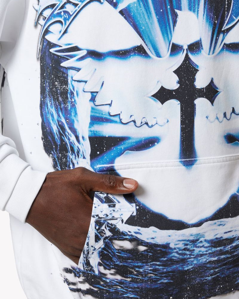 Close-up of a hoodie with graphic design featuring a cross and abstract elements.