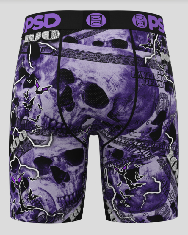 Skateboard shorts with skull design and visible brand logos on a black background