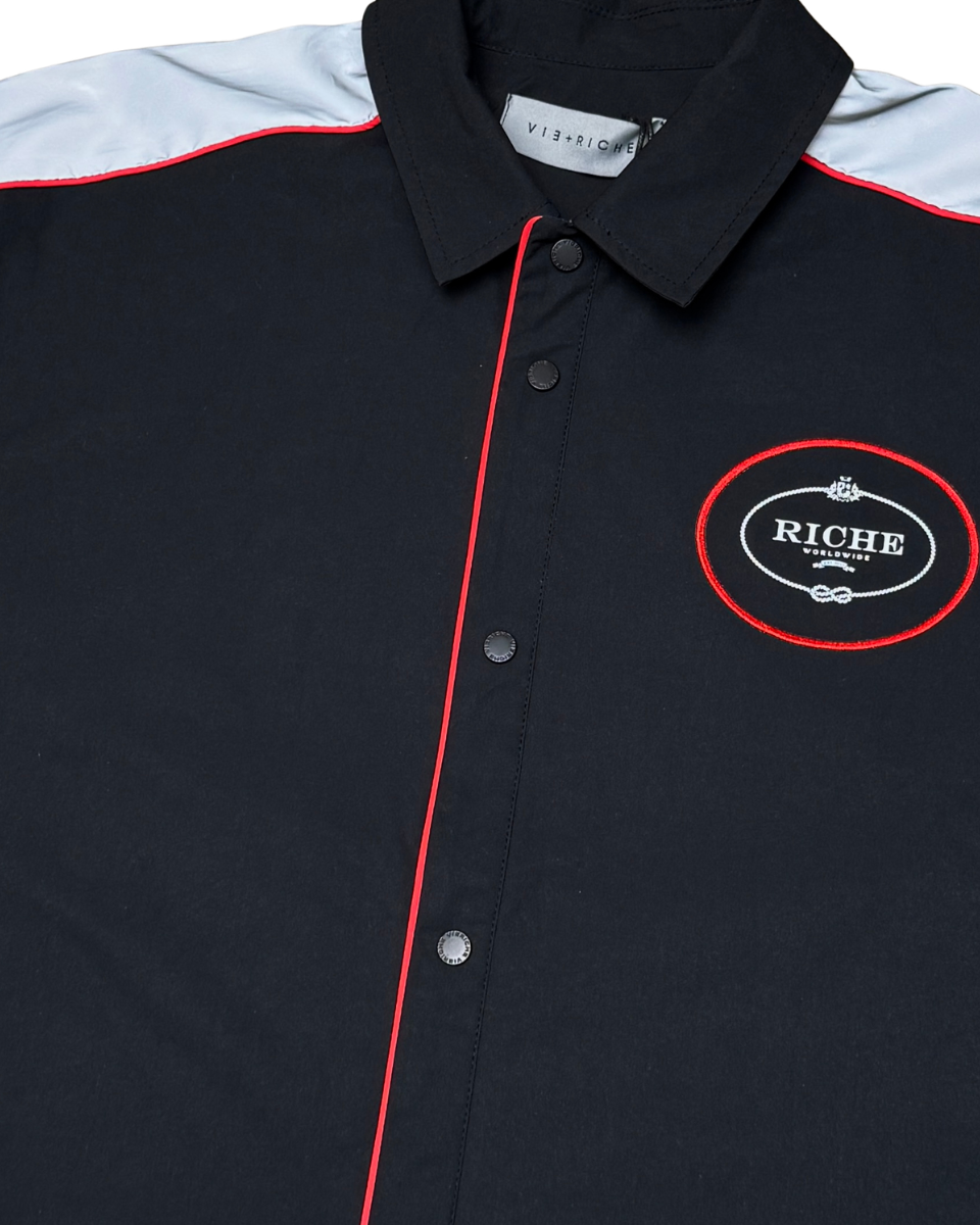 Black jacket with red accents and a logo on a white background