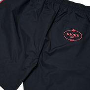 Black shorts with a red logo on a white background