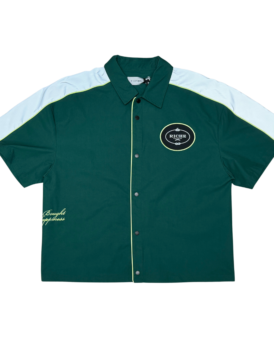 Green and white button-up shirt with a logo on a white background