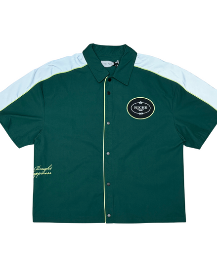 Green and white button-up shirt with a logo on a white background