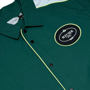 Green jacket with a logo patch on a white background