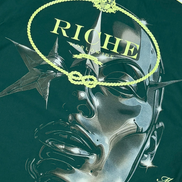 Green t-shirt with a graphic design and 'Riche' branding on a white background