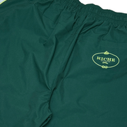 Green shorts with a Riche logo on a white background