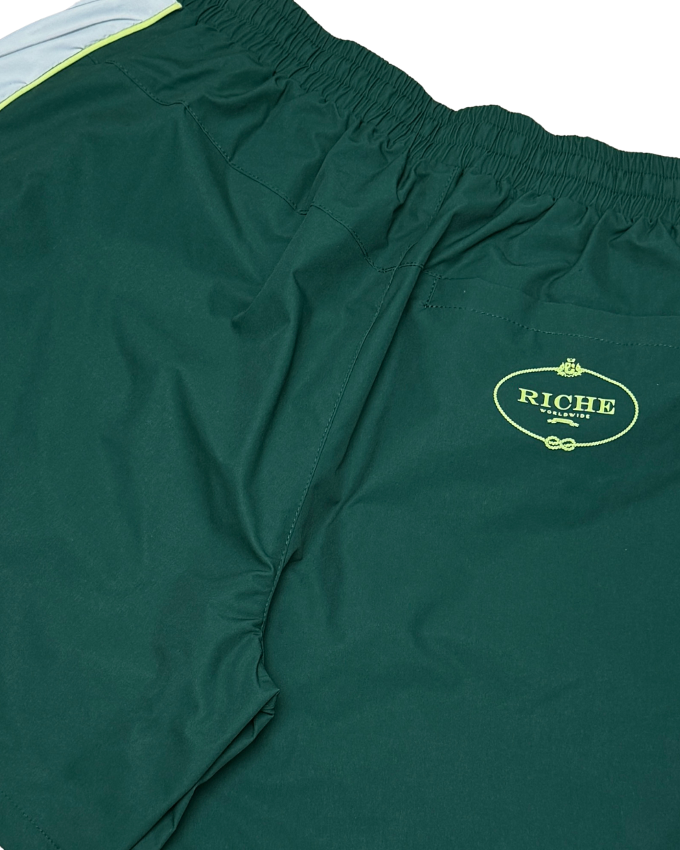 Green shorts with a Riche logo on a white background