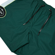 Green shorts with a brand logo on a white background