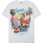 White t-shirt with a colorful graphic design of a beach scene and text on a white background