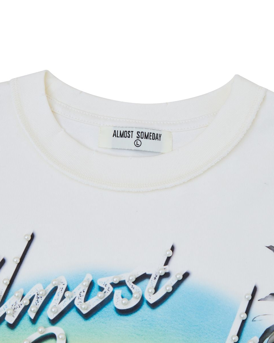 White t-shirt with 'Almost Someday' label and floral design on a white background