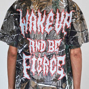 Person wearing a camouflage shirt with red text on a plain background