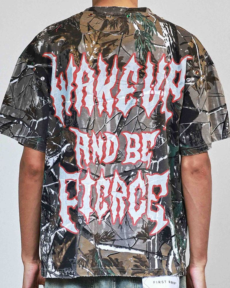 Person wearing a camouflage shirt with red text on a plain background