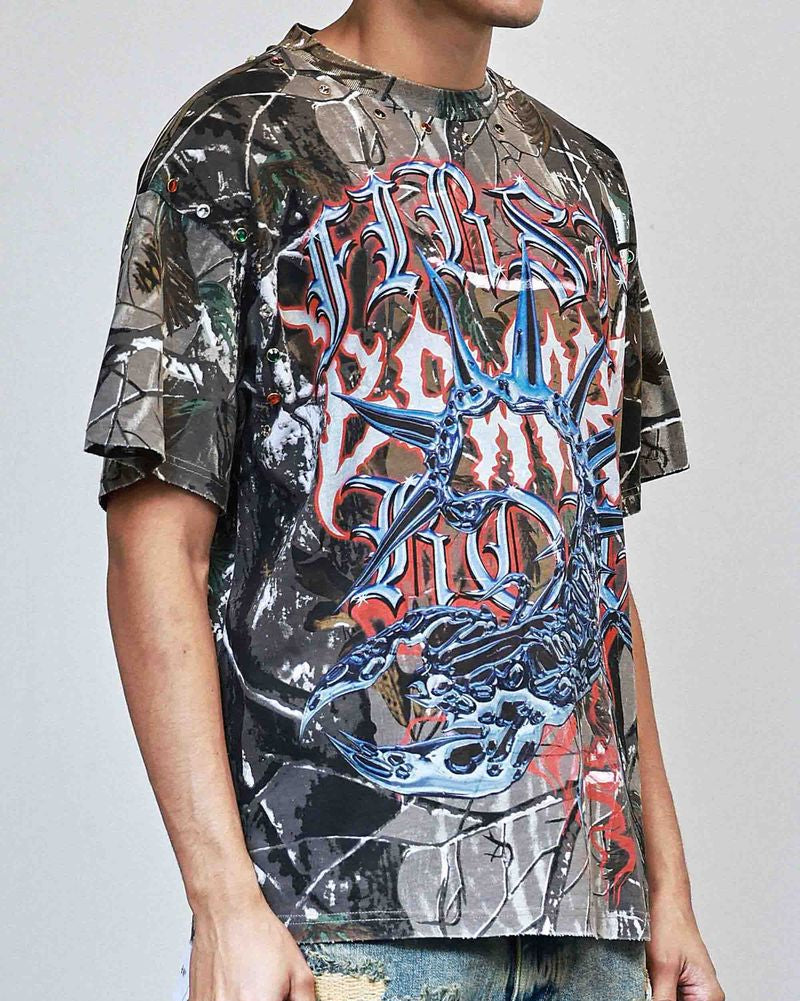 Person wearing a graphic t-shirt with a colorful design on a plain background