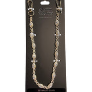 Gold wallet chain with clear stones on a black card with brand name.