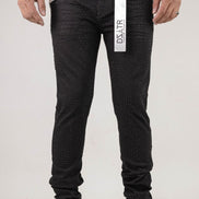 Person wearing black pants with a visible brand label on a white background