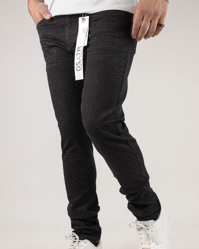 Person wearing black pants with a visible brand tag on a white background