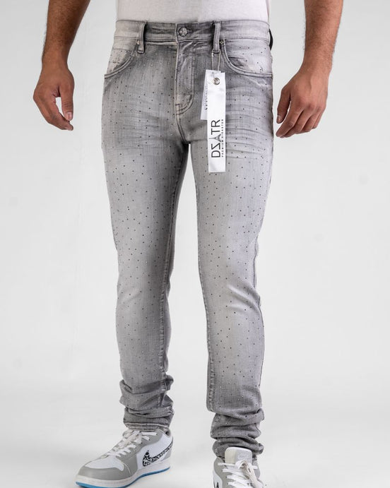 Person wearing gray jeans with a visible brand tag on a white background