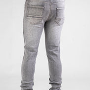 Gray jeans worn by a person on a white background