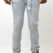 Person wearing ice blue jeans with a brand logo on a white background