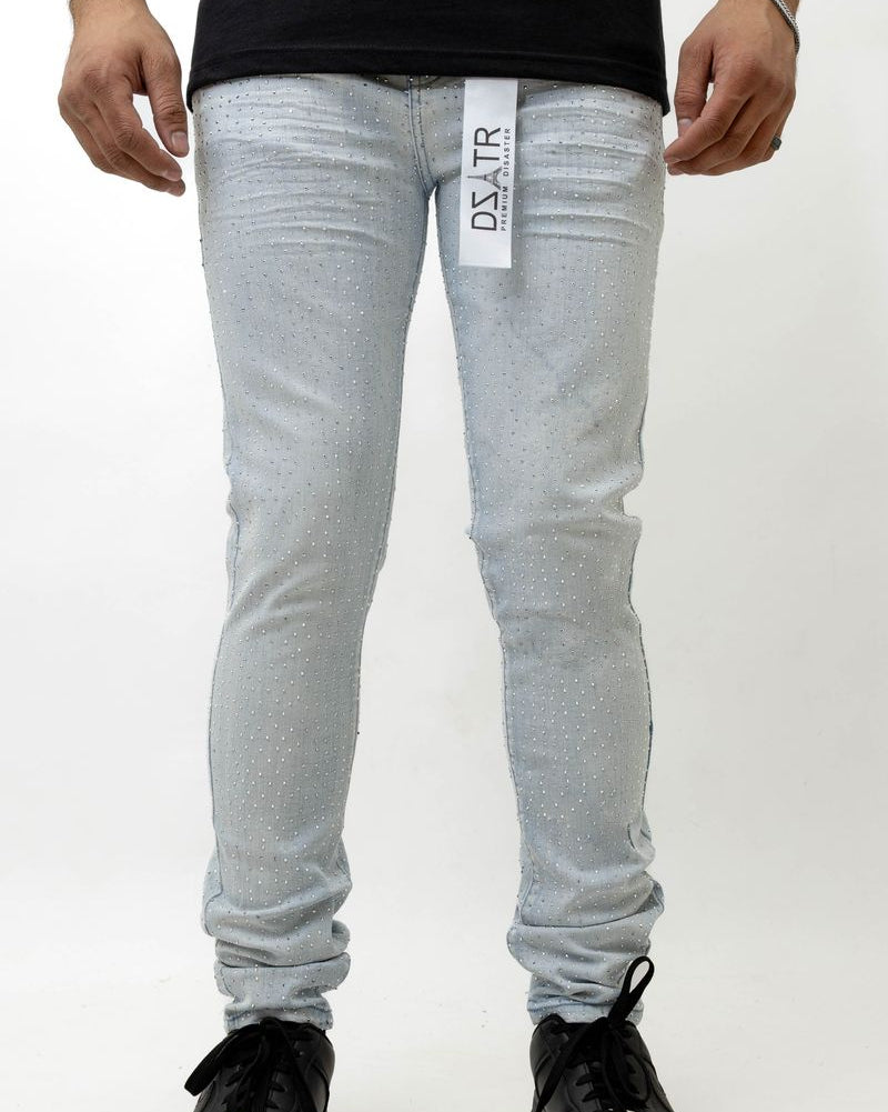 Person wearing ice blue jeans with a brand logo on a white background