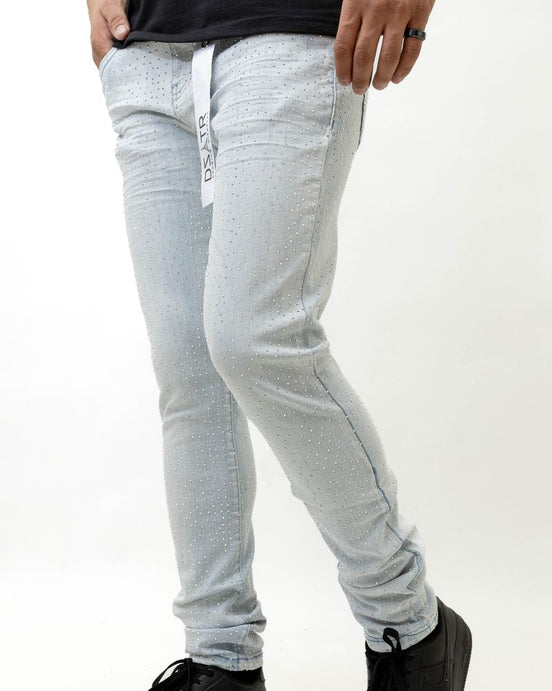 Person wearing ice blue pants and black shoes on a white background
