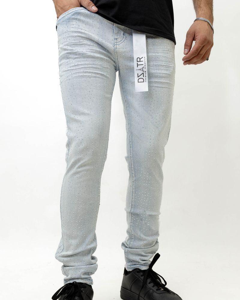 Person wearing ice blue jeans with a brand label on a white background