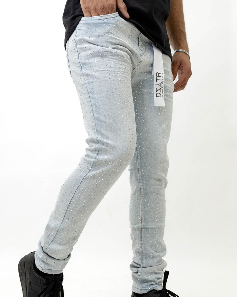 Person wearing ice blue jeans with a brand logo on a white background