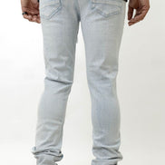 Light blue jeans worn by a person on a white background