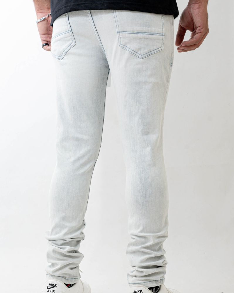 Light gray jeans worn by a person on a white background