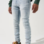 Person wearing light blue jeans and colorful sneakers on a white background