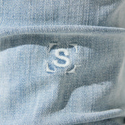 Close-up of a blue JEANS with a logo on it