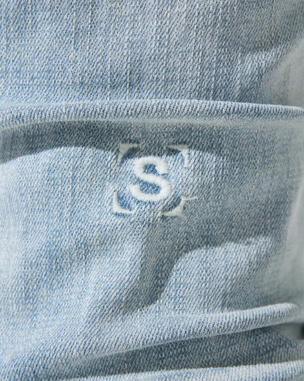 Close-up of a blue JEANS with a logo on it