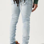 Person wearing light blue jeans and colorful sneakers on a white background