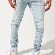Light blue jeans worn by a person on a white background