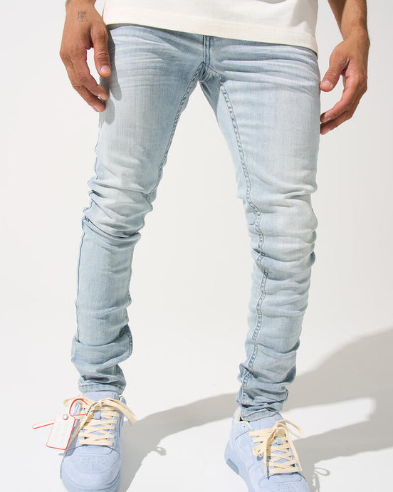 Light blue jeans worn by a person on a white background
